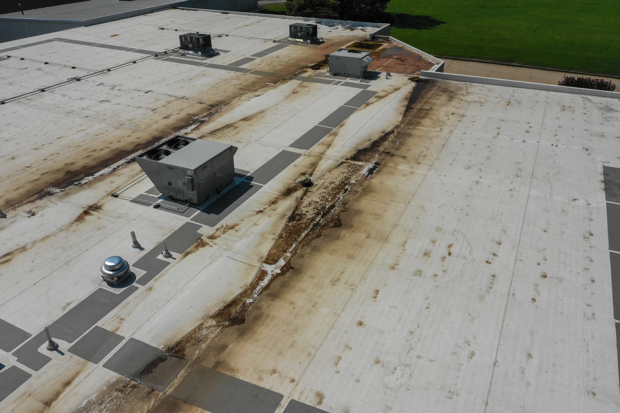 Ponding stains on a commercial roof seen from the drone