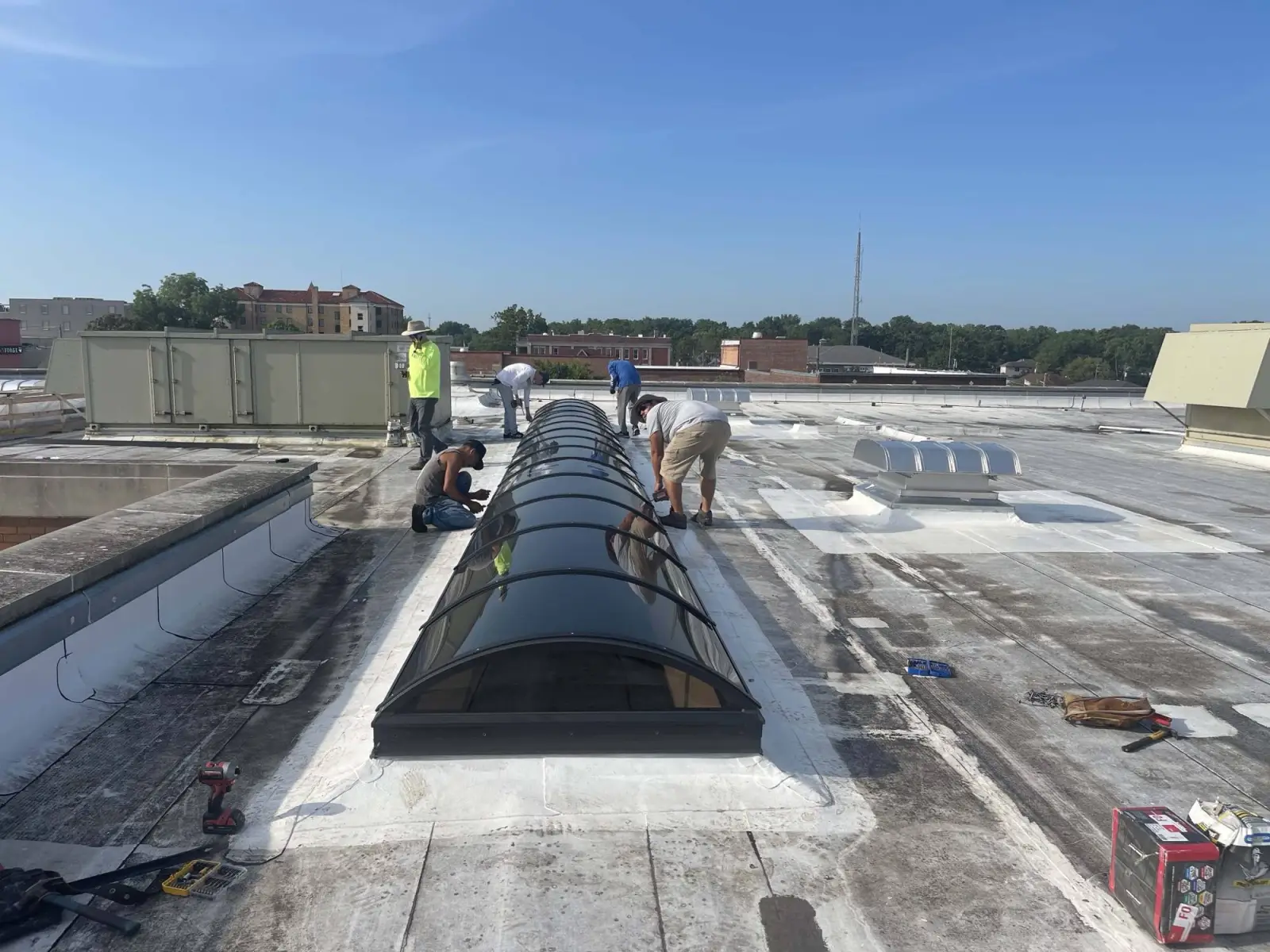 Crew setting a new skylight into a commercial roof