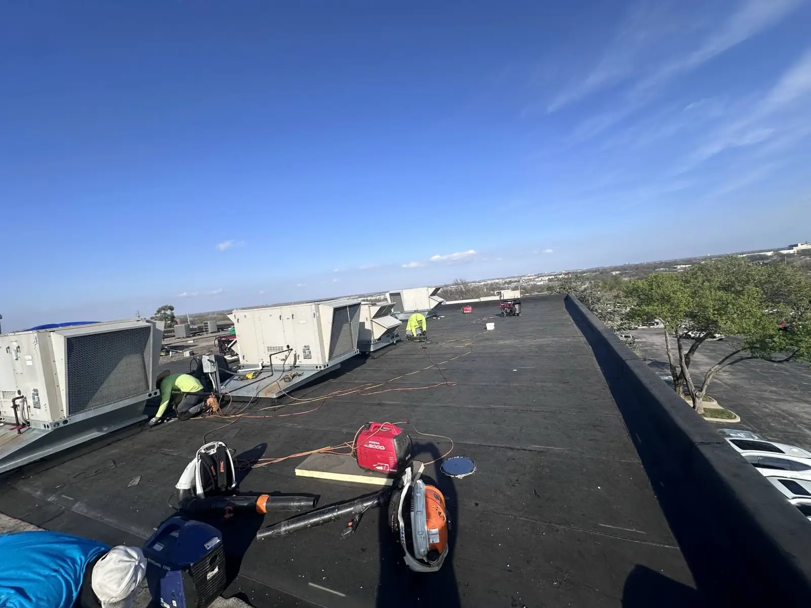 Crew tearing an old roof down to the deck on a school