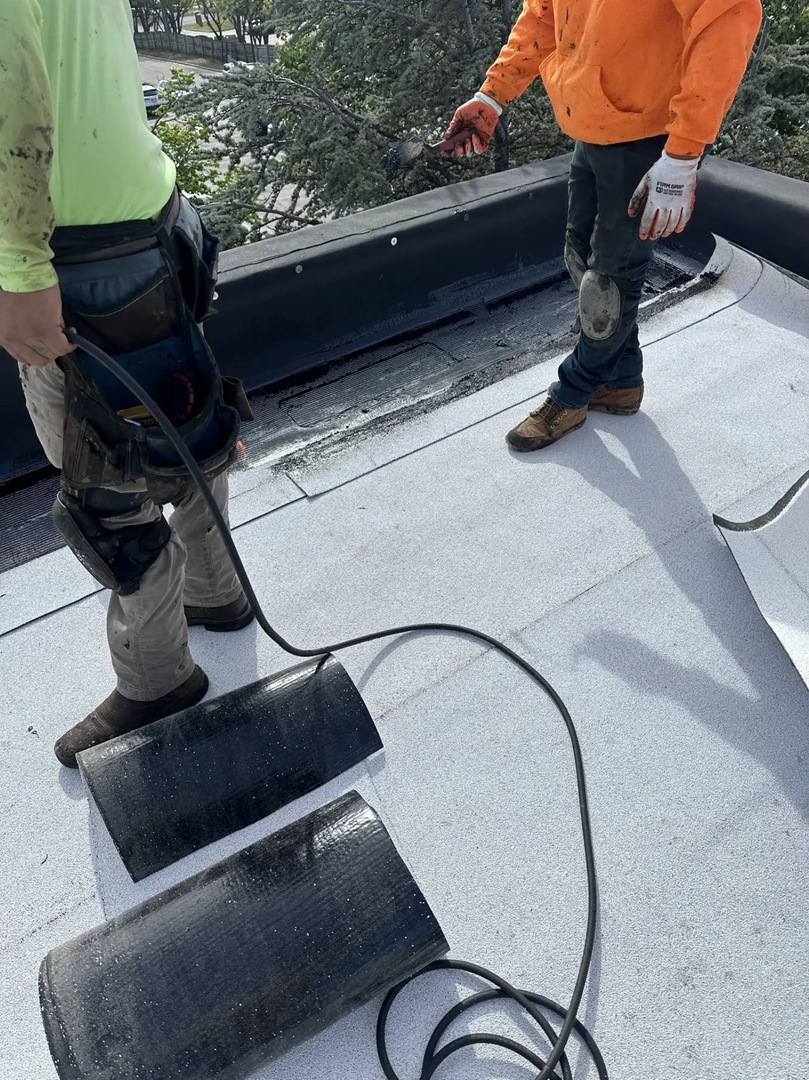 Roofspan crew heat-welding TPO seams on a school roof