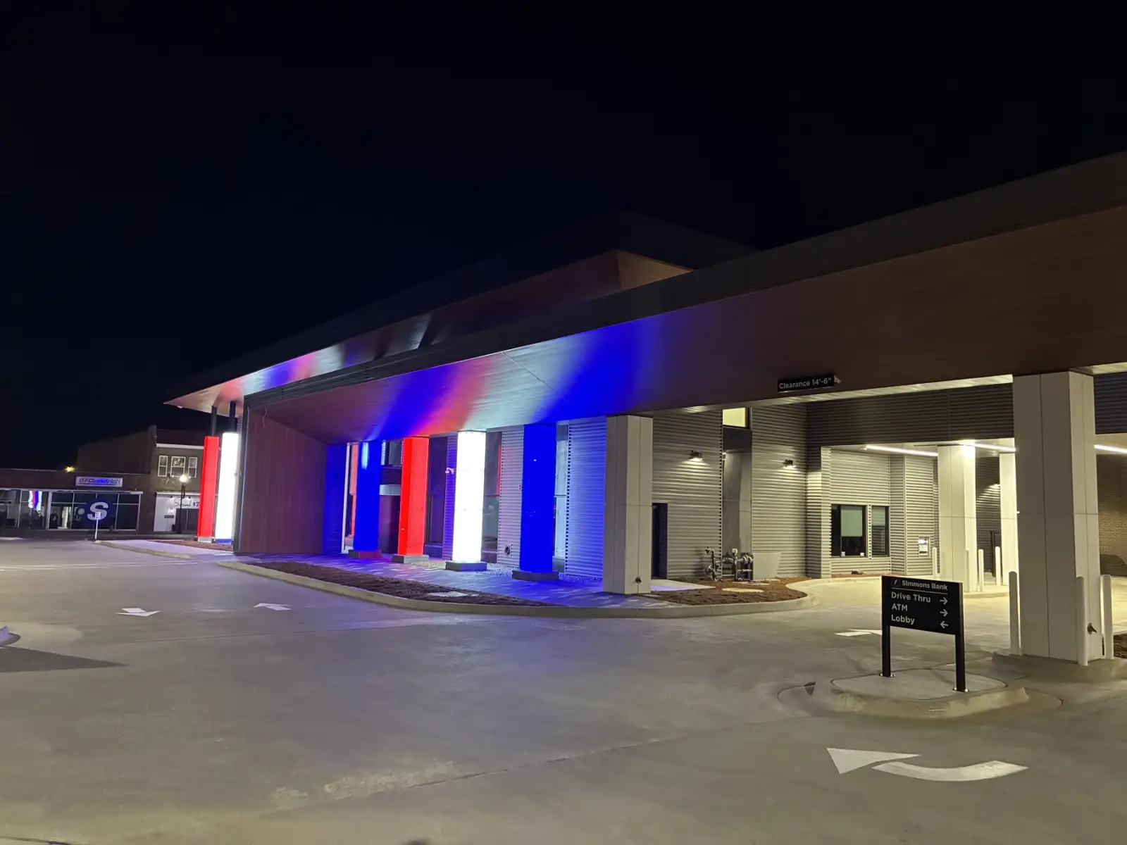 Building at night with new wall panels and canopy